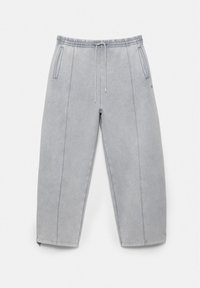 Lysegrå casual sweatpants med elastisk talje, snøre, sidelommer og synlige sømdetaljer ned langs benene.