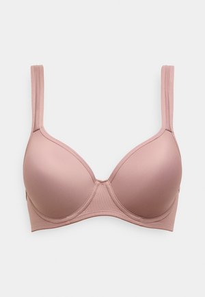 Soutien-gorge rembourré rose clair avec texture lisse, armatures, bretelles réglables et design sans coutures. Aucun élément métallique ou accent visible.
