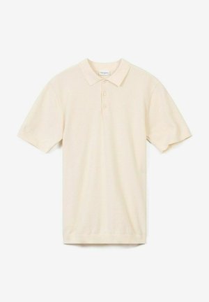 Vaaleanbeige polo-paita, joka on valmistettu tekstuurista kankaasta. Paitassa on kaulus, kolme napin aukkoa ja lyhyet hihat.