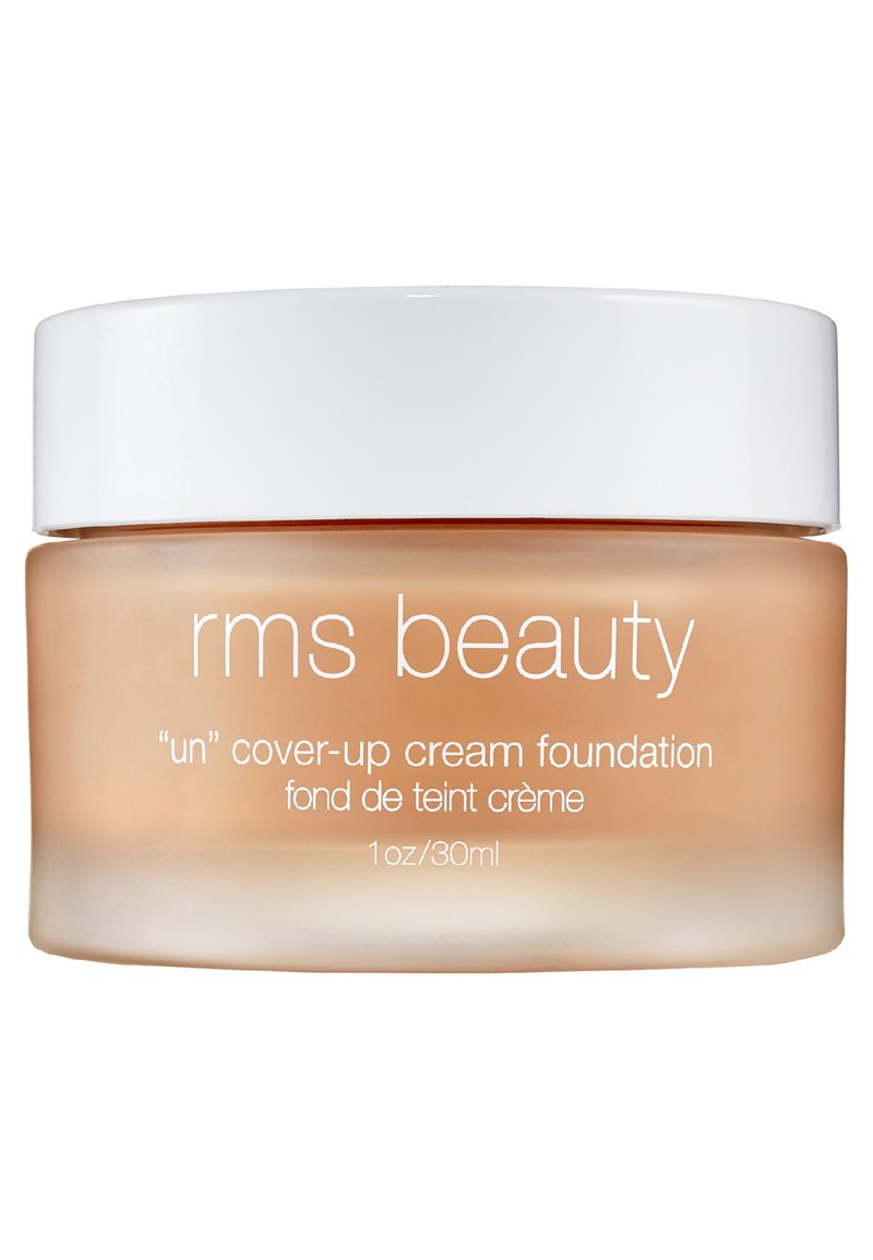 Crème foundation in een doorzichtig glazen pot met een witte deksel. De pot heeft een zachte perzikkleurige tint. De tekst is gedrukt in het wit. 1 oz/30 ml.