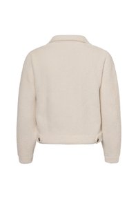 Crème-kleurige cropped jacket gemaakt van zachte, textuurstof. Heeft een klassieke kraag en twee knopen aan de achterkant voor een verstelbare pasvorm.