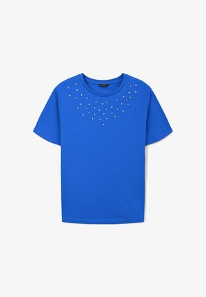 T-shirt in cotone blu con scollo rotondo, maniche corte e dettagli metallici disposti in un motivo a gradiente sulla parte anteriore.