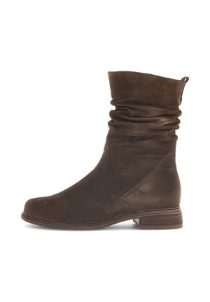 Stivale alla caviglia in suede marrone con un design morbido, punta arrotondata e tacco basso impilato. Presenta cuciture sottili e un risvolto.