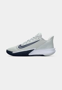 Light gray athletic shoe with dark blue sole and Nike swoosh logo on the side, designed for sports and running.