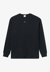 Maglietta nera a maniche lunghe in tessuto waffle con scollo rotondo, piccolo testo giallo ricamato al centro vicino al colletto, sfondo semplice.