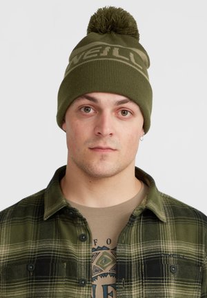 Knitted olive green beanie with a pom-pom on top and "ONeill" logo in light brown. Worn by a model with a plaid shirt underneath.