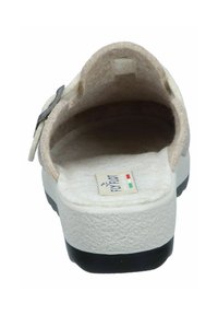 Light beige felt clogs with a textured white sole and a black base. The design includes a side buckle for adjustment and soft lining.