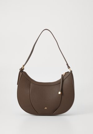 Brown leather shoulder bag with a curved shape, accented by a small gold hardware detail and textured surface, featuring a zip closure.