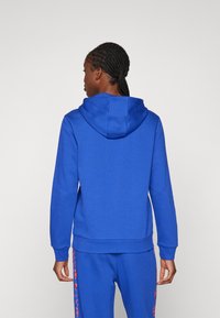 adidas Sportswear ANIMAL PRINT HOODIE - Hoodie - semi lucid blue