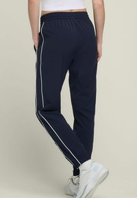 Wilson ACTION WARM-UP - Jogginghose - dunkelblau
