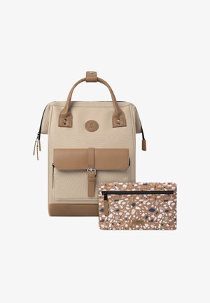 Beige backpack with brown leather accents and a front flap, includes a patterned brown pouch with white and blue details.