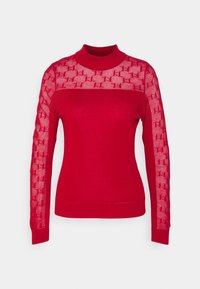 Maglione rosso a maniche lunghe con corpo tinta unita e maniche in rete trasparente con motivo. Design a collo alto con polsini e orlo a coste.