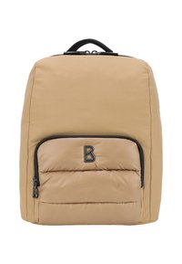Zaino imbottito color tan con forma arrotondata, dettagli in zip nera e una tasca frontale prominente. Presenta una maniglia superiore per il trasporto.