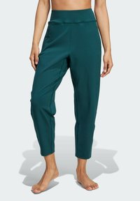 Türkisfarbene, tapered Hosen mit hohem Bund und Seitentaschen, aus einem glatten, elastischen Stoff. Knöchellang mit einem eleganten Design.