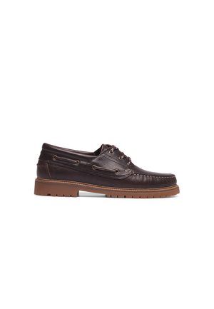 Brown leather boat shoe with a textured surface, round toe, contrasting rubber sole, and laces threaded through metallic eyelets.
