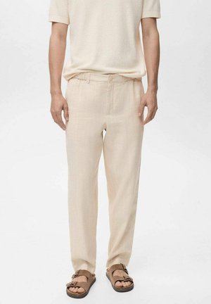 Light beige linen pants with subtle vertical stripes, flat front, and relaxed fit. Paired with brown sandals. Casual attire displayed.