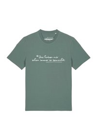 T-shirt en coton vert à manches courtes et col rond, arborant un texte blanc dans une police manuscrite sur le devant.