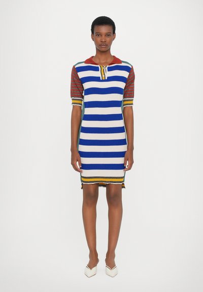 Striped knit dress featuring blue, white, and red colors, with short sleeves and a collar. Trimmed hem and two side slits at the bottom.