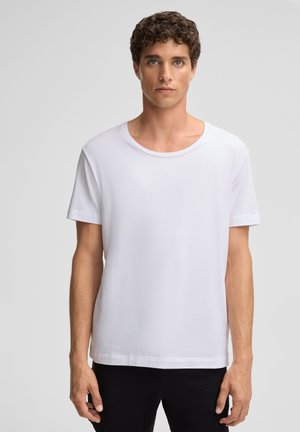 Witte t-shirt met korte mouwen van zachte katoen. Voorzien van een ronde halslijn en een relaxte pasvorm. Eenvoudig, klassiek ontwerp zonder patronen of accenten.