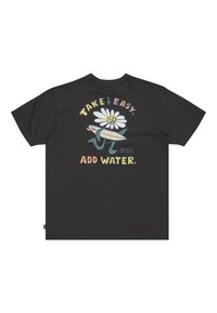T-shirt en coton noir avec un graphique d'une fleur souriante tenant une planche de surf, accompagné du texte "FAIS-LE TRANQUILLEMENT. AJOUTE DE L'EAU."