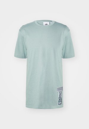 Mint green cotton t-shirt with short sleeves, round neckline, and a side label featuring graphic details and vertical stripes.