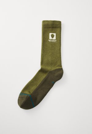 Olive green sock with ribbed texture, reinforcing heel and toe, blue accent stitching, and National Park Foundation logo.