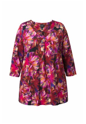 Květinový tunikový top se tříčtvrtečními rukávy, s živými růžovými, fialovými a červenými květy na černém pozadí. Výstřih do V.