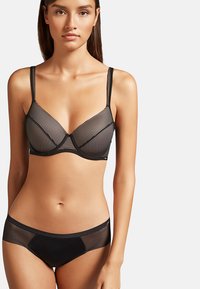 Black bra and boyshort set featuring sheer striped fabric, underwire support, and adjustable straps. Smooth texture with minimal accents.