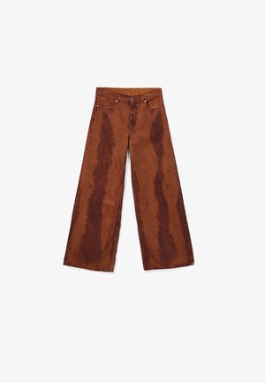 Wide-leg rust-colored jeans with darker vertical acid-wash patterns, front button closure, and five-pocket design laid flat on a white background.