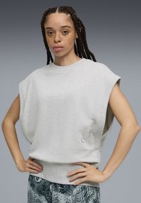 Gray oversized sleeveless sweatshirt made of soft fabric with a ribbed neckline and subtle logo detail in light gray on the front.