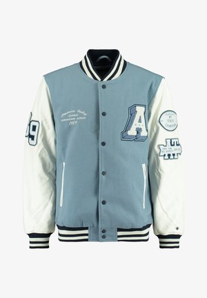 Veste universitaire bleu clair et blanche avec col et poignets rayés, ornée de patchs dont un grand "A", "89" et des insignes de championnat.