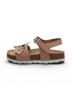 Sandalo beige per bambini con cinturino alla caviglia regolabile, suola in sughero, battistrada bianco e fiore decorativo sulla cinghia anteriore.