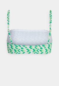 Bralette verde com padrão, com alças finas ajustáveis. O material aparenta ser suave, com um forro interior branco e um design abstrato colorido na parte exterior.