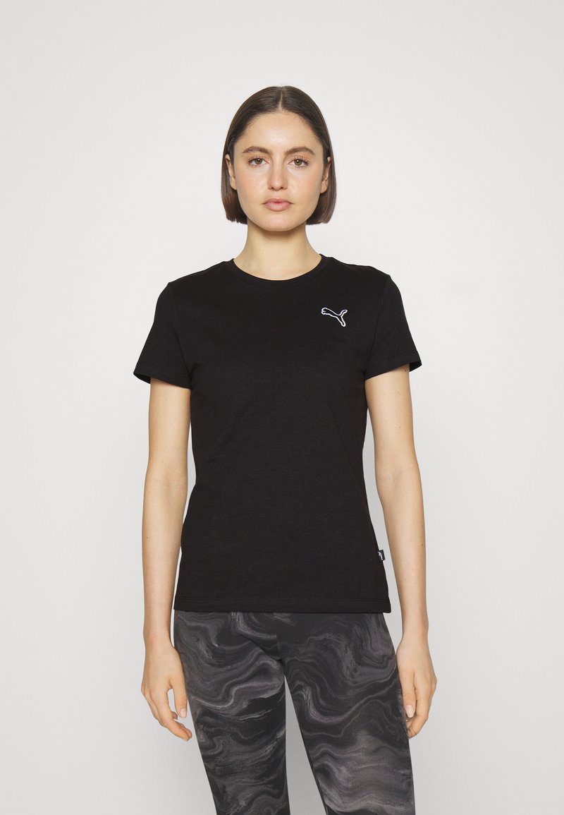 T-shirt in cotone nero con maniche corte, scollo rotondo e un piccolo logo bianco di Puma sul lato sinistro del petto. Abbinato a leggings neri fantasia.