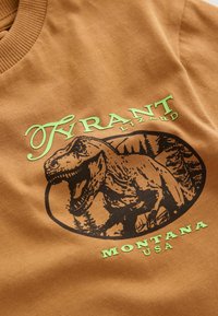 Unselected, tan dino back print