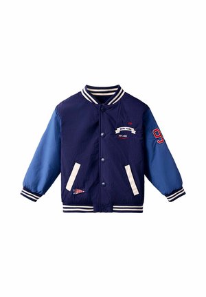 Marineblaue und hellblaue Jacke mit weißen Streifen am Kragen und an den Bündchen. Verfügt über ein Logo, die Nummer "9" und zwei frontale Taschen.