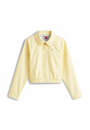 Giacca gialla cropped con colletto, zip frontale, orlo elasticizzato e dettagli logo sul lato sinistro del petto. Tessuto morbido e leggero.