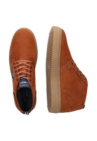 Brown suede high-top sneakers with a textured finish, contrasting rubber sole, and rounded toe. Features laces and a small logo tag.