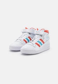 White high-top sneakers with red, blue, and turquoise stripes. Features a velcro strap and perforated toe. Smooth leather and rubber sole.