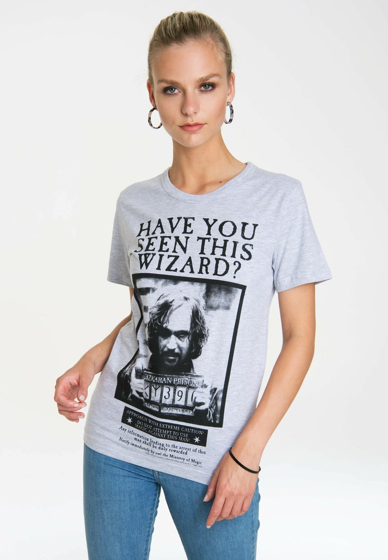 Gray cotton t-shirt featuring a front print of a wizard's mugshot with text "HAVE YOU SEEN THIS WIZARD?" and caution details below.