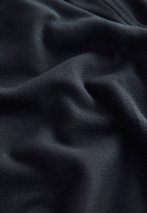 Black fabric with a soft, smooth texture, featuring subtle draping and gentle waves, indicative of lightweight and flexible material.