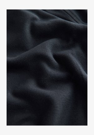 Black fabric with a soft, smooth texture, featuring subtle draping and gentle waves, indicative of lightweight and flexible material.