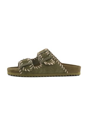 Olive green suede slide sandal with two adjustable buckled straps and white whipstitch detailing on the edges and sole.