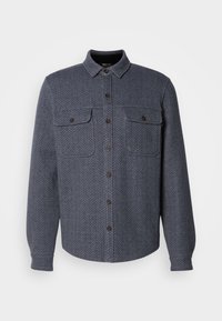 Dark gray flannel shirt featuring a herringbone pattern, a button-up front, two chest pockets, and button cuffs. Classic collar design.