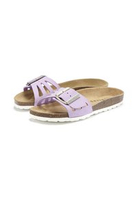 Lilac suede sandals with cut-out design and a silver buckle. Cork footbed on a white rubber sole. Minimalist and easy to wear.