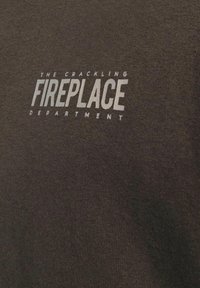 Dark brown fabric featuring the text "THE CRACKLING FIREPLACE DEPARTMENT" in bold white letters. Smooth texture, casual design.