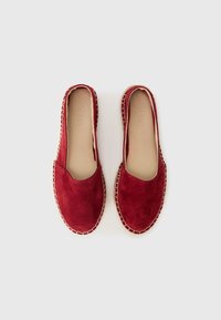 Crvene suede espadrile s dizajnom na slip-on, kontrastnim bež šavovima oko potplata i glatkom, jednostavnom unutrašnjosti.