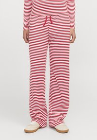 Rote und weiße gestreifte Lounge-Hosen aus weichem Material, mit lässigem Schnitt, elastischem Bund und Kordelzug-Detail.