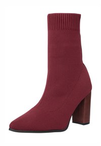 Botín estilo calcetín en color granate, con tacón alto de bloque, punta puntiaguda y parte superior acanalada. Presenta una textura de tela lisa y una suela negra sólida.