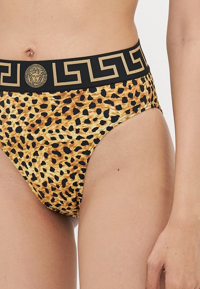 Pūķa raksta bikini ar melnu jostu, kurā ir Grieķu atslēgas motifs un zelta motīvs priekšpusē. Gluda auduma un augstākā jostas dizains.